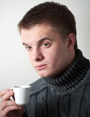 young man with a cup coffee