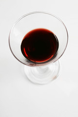 Red wine in wineglass isolated on white background ..