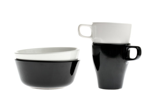 Two black and white ceramic bowls and cups isolated on white
