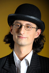 young man in bowler hat and optic glasses