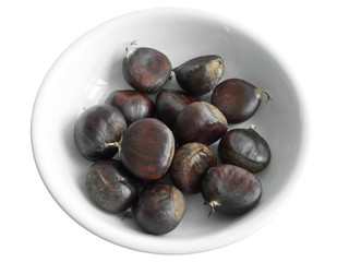 Chestnuts on white dish.
