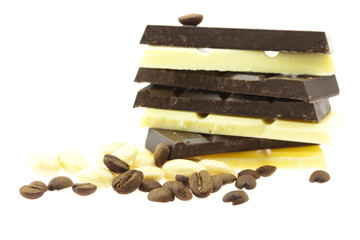 mountain of chocolate, nuts and coffee beans isolated on white