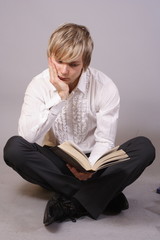 young man with books, reading and studying