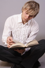 young man with books, reading and studying