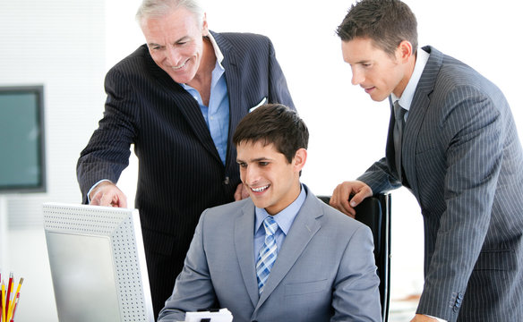 Positive businessmen working at a computer