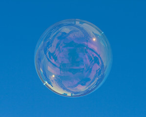 big soap bubble over a blue sky