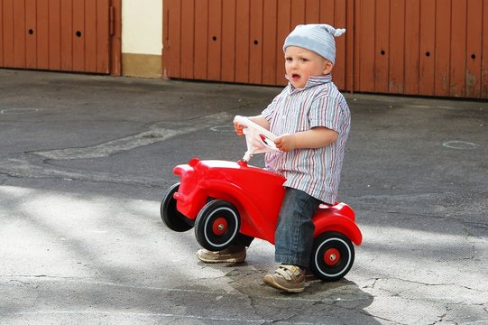 Funny boy with his toy car