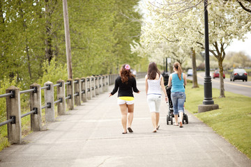 Women walking on a boardwalk.