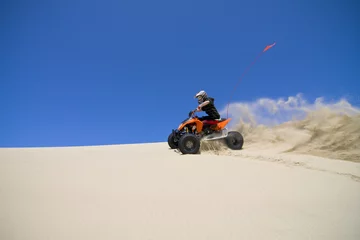 Foto op Aluminium Large sand spray from ATV quadbike rider in the dunes © Raven