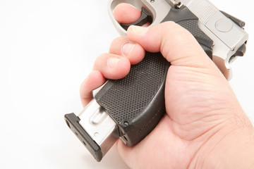 Magazine being removed from handgun