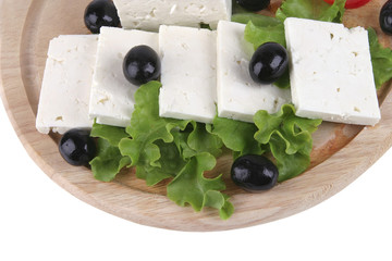 soft cheese with olives on plate