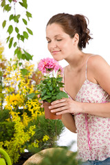Gardening - woman holding flower pot smelling flower