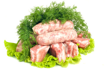 Pork meat, Sausages and dill on green salad