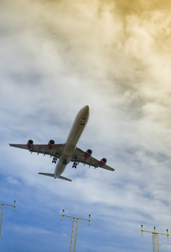 passenger jet taking off or landing through gradient clouds