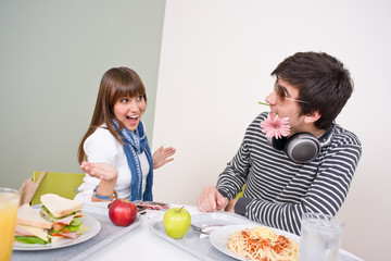 Student cafeteria - teenage couple having fun during lunch break