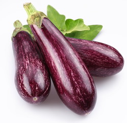 Purple eggplants with leaves on white background