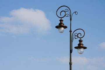 Antique lamppost on blue sky