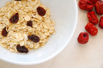 Small serving of healthy oatmeal with raisins