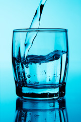 Stream of vodka in a glass