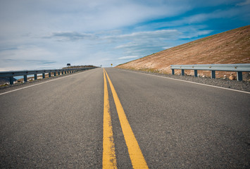 Fototapeta premium vibrant image of highway and blue sky