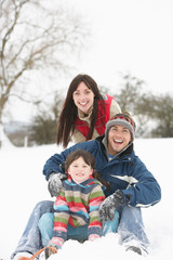 Fototapeta na wymiar Family Having Fun In Snowy Countryside