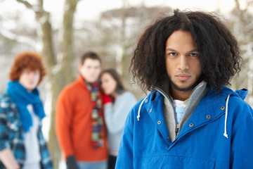 Group Of Teenage Friends Having Fun In Snowy Landscape Wearing S