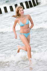 Beautiful girl running at tha beach