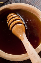wood bowl with honey and spoon