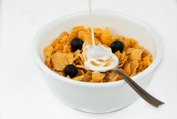 Pouring milk into bowl of cereal