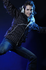 Hip-hop style dancer posing on blue light studio