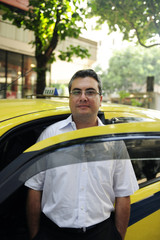 portrait of a taxi driver with cab
