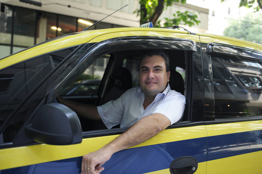 Portrait Of A Taxi Driver With Cab