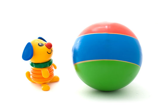 multi colored plastic dog toy and three colored rubber ball