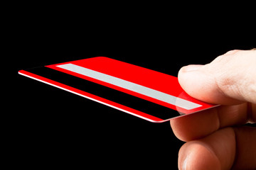 Credit card in a hand on a black background