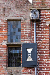 Detail of a brick wall with window and drainpipe