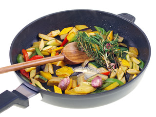 mixed vegetables cooking in a pan isolated on white