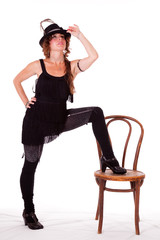 Fototapeta premium Cabaret dancer posing with leg on chair