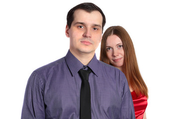 Confident man and a beautiful woman in red behind him