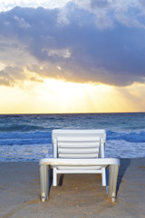 Fototapeta na wymiar Empty chaise lounge before ocean
