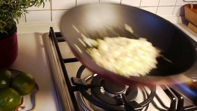 Shaking Onions in Pan