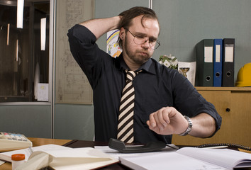 Exhausted office worker waiting the day to end.
