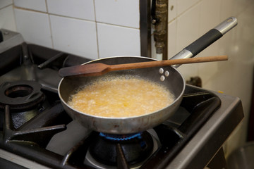 cooking beer risotto in restaurant kitchen
