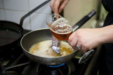cooking beer risotto in restaurant kitchen
