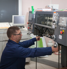 Printer working at his new offset machine