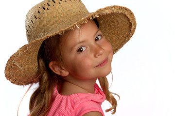 Portrait of a pretty little girl wearing a straw hat