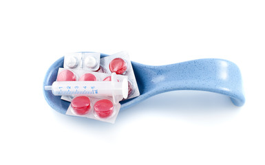 Pills in  spoonl