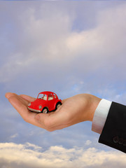 The Hand of the Businessman with the lovely red Car