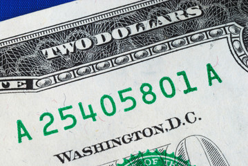 Close up view of the serial number of a dollar bill