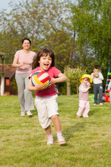 Child with ball running