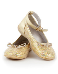 Pair of shiny golden shoes for girls on white background.